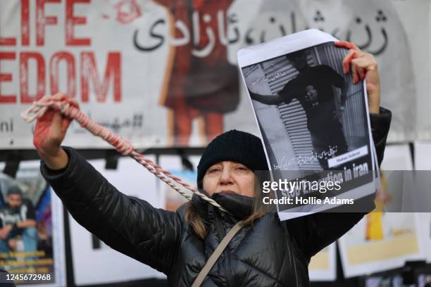 Demonstrator holds a noose around her neck during a One Law for All dance protest at Piccadilly Circus on December 17, 2022 in London, England. The...