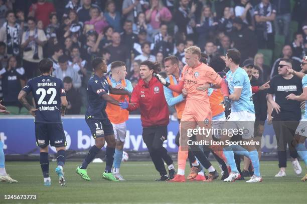 Tom Glover of Melbourne City FC is taken off the field by team mates after being struck on the head during the A-League Men's football match between...