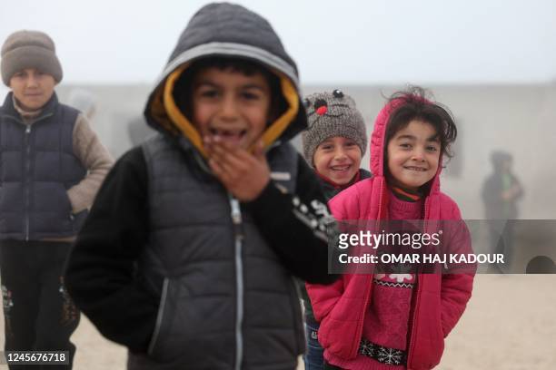 Pupils play at their school's rooftop during break as the fog engulfs a camp for the internally displaced in the al-Zawf area in the northwestern...