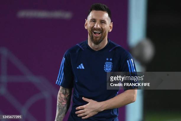 Argentina's forward Lionel Messi laughs during a training session at Qatar University training site 3 in Doha on December 17 on the eve of the Qatar...