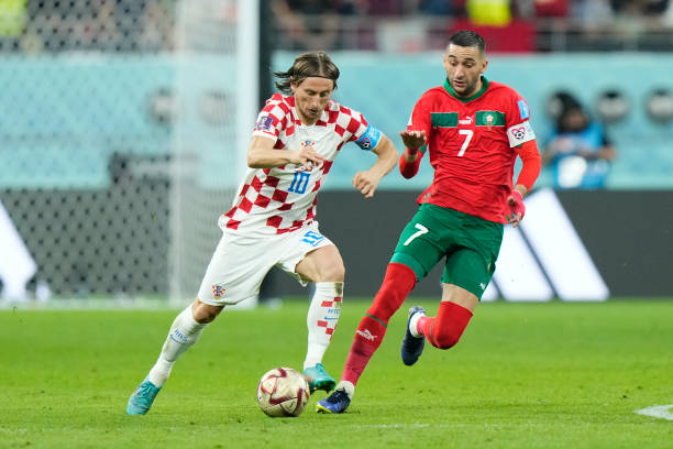 Luka Modric central midfield of Croatia and Real Madrid and Hakim Ziyech attacking midfield of Morocco and Chelsea FC compete for the ball during the...