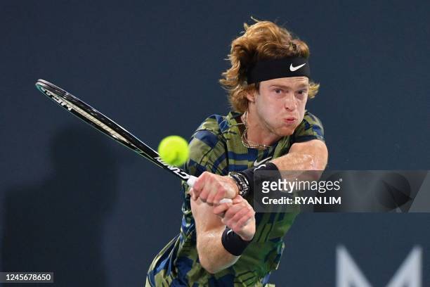 Russia's Andrey Rublev returns the ball to Spain's Carlos Alcaraz during the semi-final of UAE's Mubadala World Tennis Championship, in Abu Dhabi on...