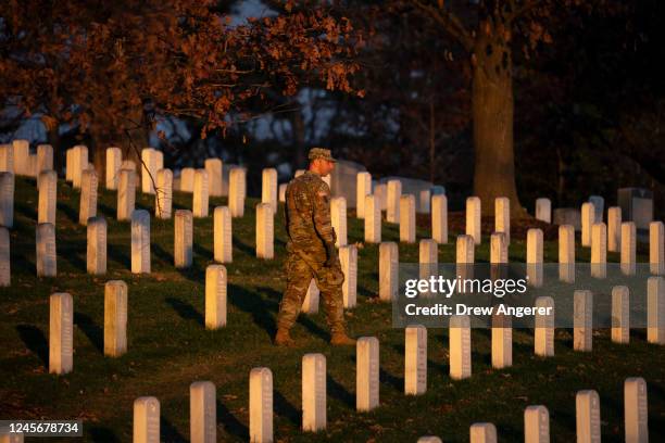 Lt. Col. Max Pappas surveys the grounds at dawn before the gates open for volunteers to wreaths on headstones at Arlington National Cemetery on...