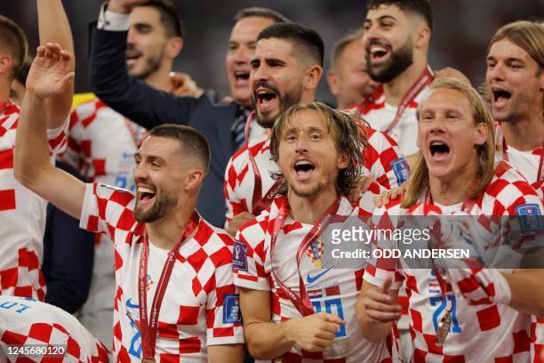 Croatia's midfielder Luka Modric , Croatia's midfielder Mateo Kovacic and Croatia's defender Domagoj Vida celebrates with teammates after winning the...