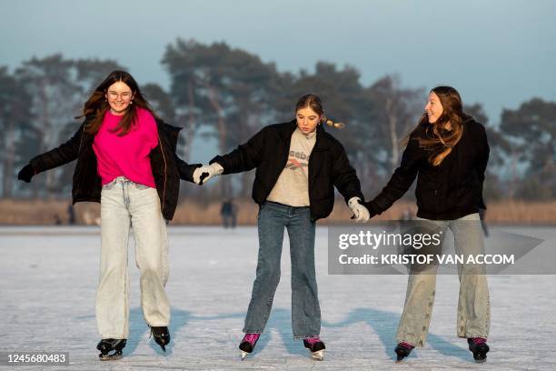 Girls pictured on ice on the ponds at the Kalmthoutse Heide nature reserve in Kalmthout are opened for ice-skating on Saturday 17 December 2022....