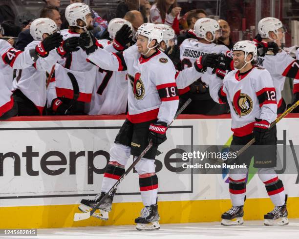 Drake Batherson of the Ottawa Senators celebrates a goal with teammates on the bench during the first period of an NHL game against the Detroit Red...