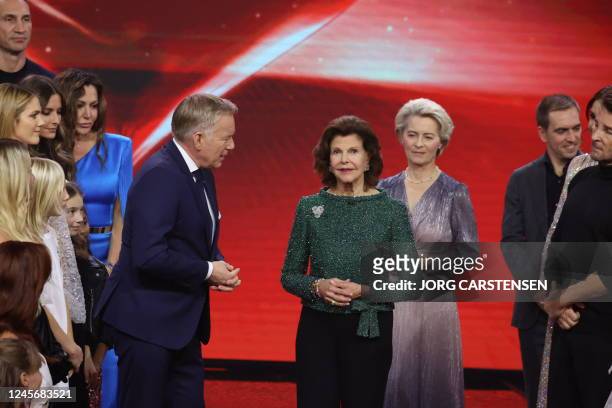Queen Silvia of Sweden, President of the European Commission Ursula von der Leyen and other guests react on stage during the "Ein Herz fuer Kinder"...