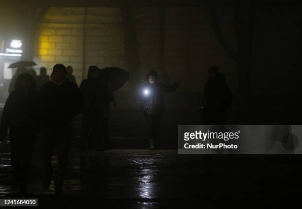 https://media.gettyimages.com/id/1245684050/photo/ukrainians-walk-at-the-street-at-the-dark-illuminating-the-road-with-a-flashlight-during-a.jpg?s=612x612&w=gi&k=20&c=_fvDLZVz9Nx-2nrMZuFwFRSOLX-NNY5RK6sIZRVsrUM=