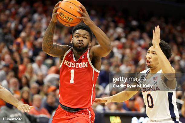 Jamal Shead of the Houston Cougars drives past Kihei Clark of the Virginia Cavaliers in the first half during a game at John Paul Jones Arena on...