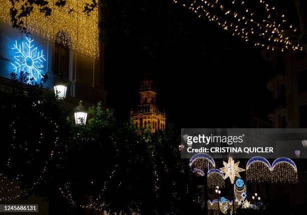 The Giralda bell tower is framed by the Christmas lights that decorate the city Seville on December 17, 2022.