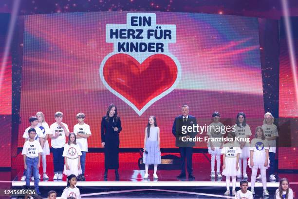 Vicky Leandros, Violetta and Roland Kaiser perform on stage during the "Ein Herz fuer Kinder" Gala at Studio Berlin Adlershof on December 17, 2022 in...