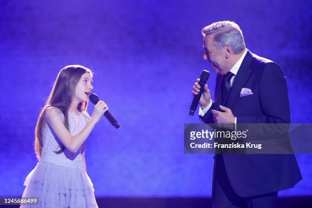 Violetta and Roland Kaiser perform on stage during the "Ein Herz fuer Kinder" Gala at Studio Berlin Adlershof on December 17, 2022 in Berlin, Germany.