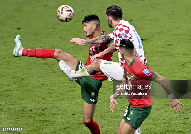 Marko Livaja of Croatia in action against Achraf Dari of Morocco during the FIFA World Cup Qatar 2022 3rd Place Match between Croatia and Morocco at...