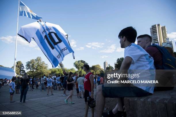 Fans look at a giant jersey of Argentine forward Lionel Messi displayed in Rosario, Argentina, on December 15 on the eve of the Qatar 2022 World Cup...