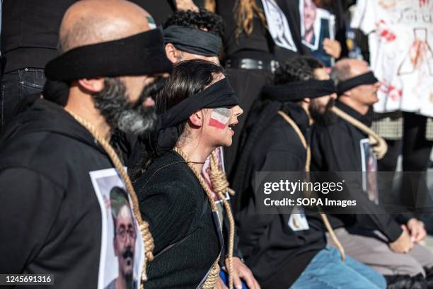Protesters perform an execution scene with ropes around their necks during the demonstration. Mahsa Amini's death has sparked weeks of violent...