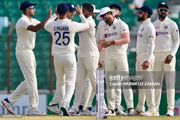Indias players celebrate the dismissal of Bangladesh's Mehidy Hasan Miraz during the fifth day of the first cricket Test match between Bangladesh and...