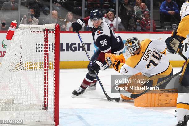 Goaltender Juuse Saros of the Nashville Predators makes a save against Mikko Rantanen of the Colorado Avalanche at Ball Arena on December 17, 2022 in...