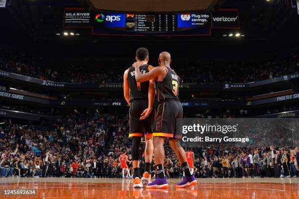 Devin Booker and Chris Paul of the Phoenix Suns looks on during the game against the New Orleans Pelicans on December 17, 2022 at Footprint Center in...