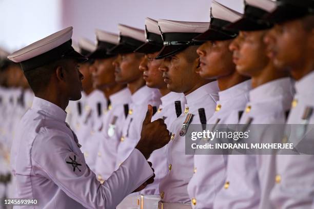 Sailor inspects the uniform of members of the ceremonial honor guards of the crew during the commissioning of INS Mormugao, the second stealth guided...