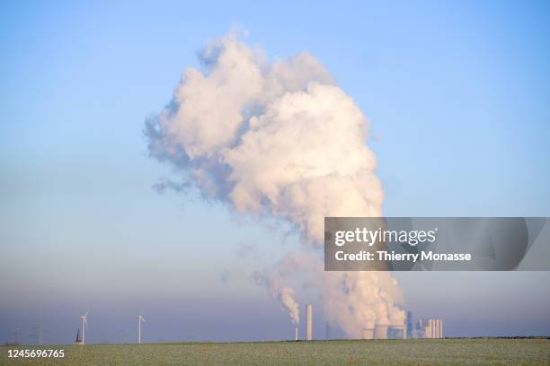 Smoke from the Weisweiler power plant is seen from Röhe on December 17, 2022 in Eschweiler, Germany. The Weisweiler power plant is a power plant...