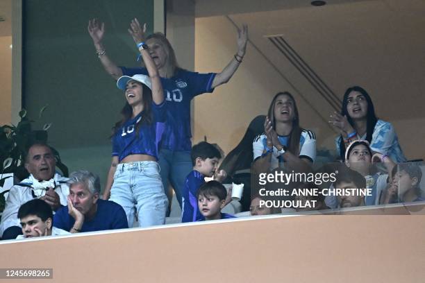 Argentina's forward Lionel Messi's wife Antonela Roccuzzo , mother Celia Maria Cuccittini and father Jorge Messi wait on the stands for the Qatar...