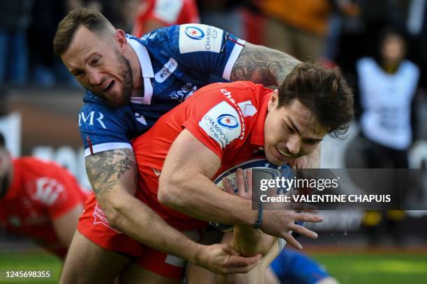 Toulouse's French scrum-half Antoine Dupont fights for the ball with Sale's Scottish full back Byron McGuigan during the European Rugby Champions Cup...