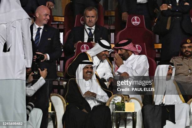Qatar's Emir Sheikh Tamim bin Hamad al-Thani and his father Qatar's former Emir Sheikh Hamad bin Khalifa al-Thani attend the Qatar 2022 World Cup...