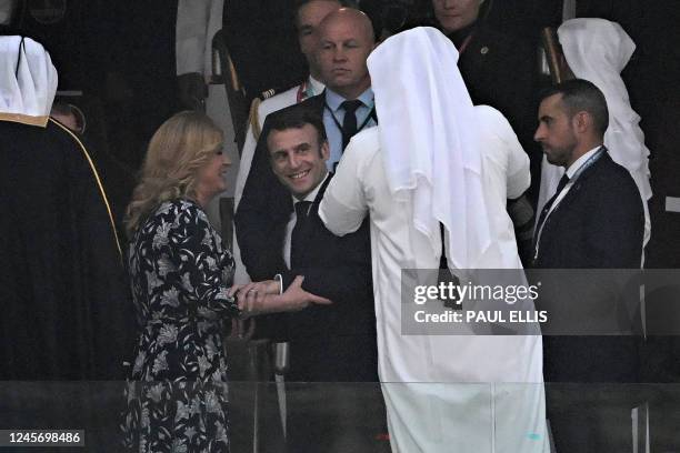 French President Emmanuel Macron and Croatian former president Kolinda Grabar-Kitarovic pose for photos ahead of the start of the Qatar 2022 World...