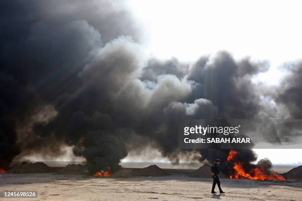 Iraqi government officials destroy nearly six tons of drugs, some of which had been in storage for more than a decade, in Baghdad's Nahrawan area on...