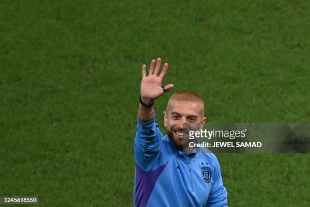 Argentina's midfielder Alejandro Gomez waves from the pitch before the start of the Qatar 2022 World Cup final football match between Argentina and...
