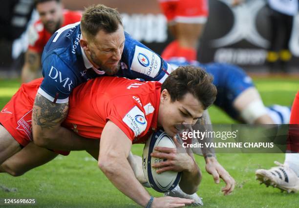 Toulouse's French scrum-half Antoine Dupont is tackled by Sale's Scottish full back Byron McGuigan during the European Rugby Champions Cup pool B...