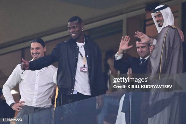 French football player Paul Pogba gives a thumbs-up as he attends with Swedish football player Zlatan Ibrahimovic and French President Emmanuel...