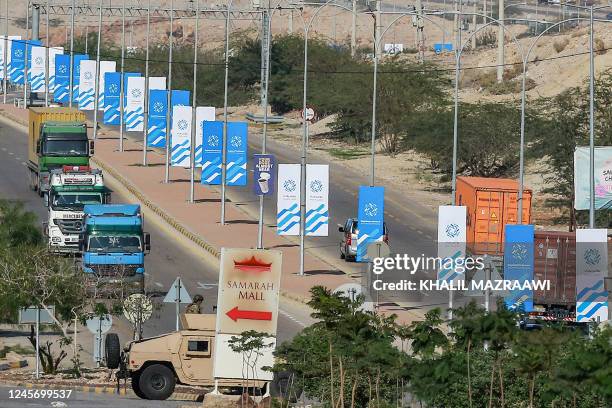 Jordanian military humvee is seen between signs bearing the name and logo of the "Baghdad Conference for Cooperation and Partnership" are displayed...