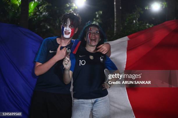 Soccer fans with their faces painted in the colours of Frances national flag cheer for the French soccer team ahead the Qatar 2022 FIFA World Cup...