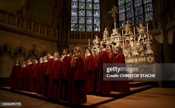 Members of the Regensburger Domspatzen girls' choir sing during their first appearance during a service at the Regensburg Cathedral on December 18,...