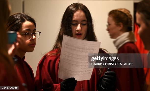 Members of the Regensburger Domspatzen girls' choir prepare for their first appearance during a service at the Regensburg Cathedral on December 18,...