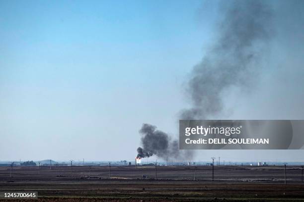 Smoke plumes rise from gas flaring at oil wells in the countryside near the town of al-Qahtaniyah in Syria's northeastern Hasakah province, close to...