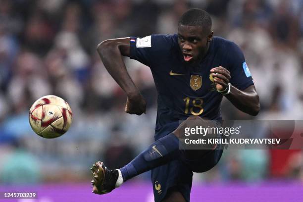 France's defender Dayot Upamecano kicks the ball during the Qatar 2022 World Cup final football match between Argentina and France at Lusail Stadium...
