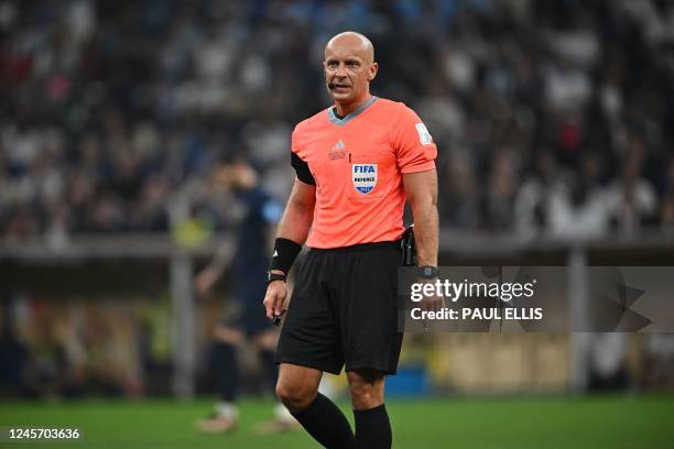 Polish referee Szymon Marciniak officiates during the Qatar 2022 World Cup final football match between Argentina and France at Lusail Stadium in...