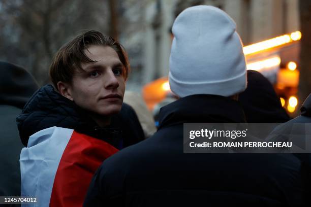 France's football fan wrapped in a French flag looks on as he watches the final football match of the Qatar 2022 World Cup between Argentina and...