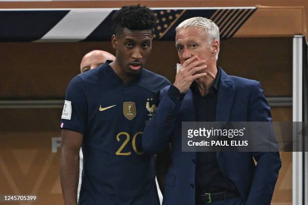 France's forward Kingsley Coman talks with France's coach Didier Deschamps as he waits to come on as a substitute during the Qatar 2022 World Cup...