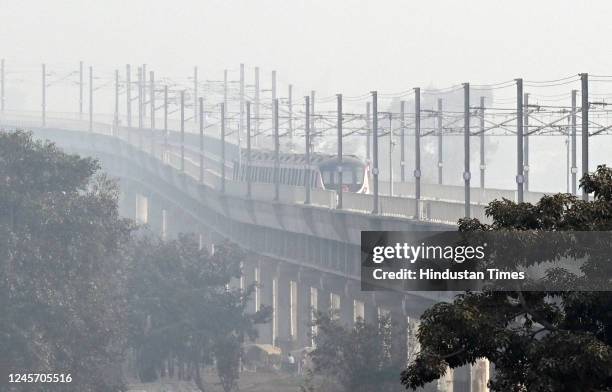 Delhi Metro rail seen near Yamuna Bank on a cold foggy afternoon on December 18, 2022 in New Delhi, India.