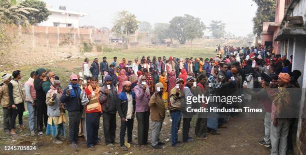 Voters standing in queue to cast their vote during the first phase of Bihar Municipal Corporation elections at a polling booth at Danapur on December...