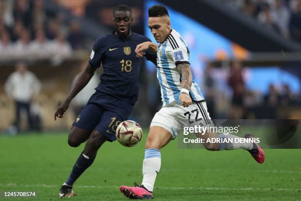 Argentina's forward Lautaro Martinez fights for the ball with France's defender Dayot Upamecano during the Qatar 2022 World Cup final football match...