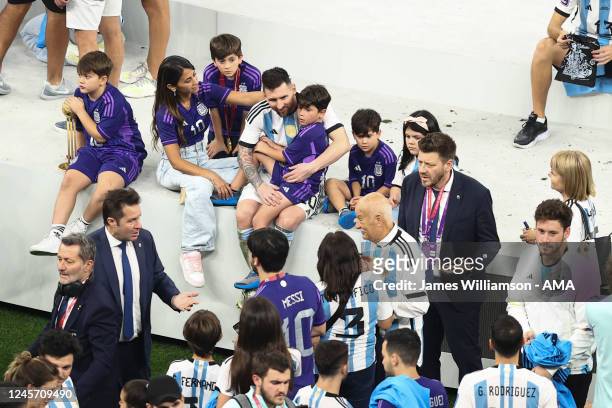 Lionel Messi of Argentina sits with his family as they celebrate him winning the World Cup during the FIFA World Cup Qatar 2022 Final match between...