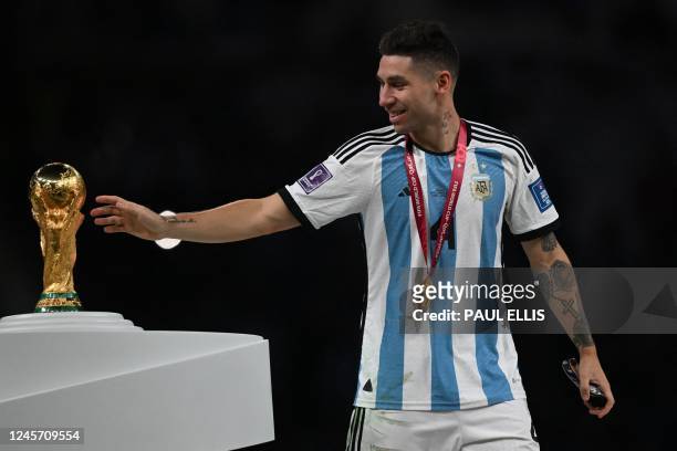 Argentina's defender Gonzalo Montiel touches the FIFA World Cup Trophy during the trophy ceremony after Argentina won the Qatar 2022 World Cup final...