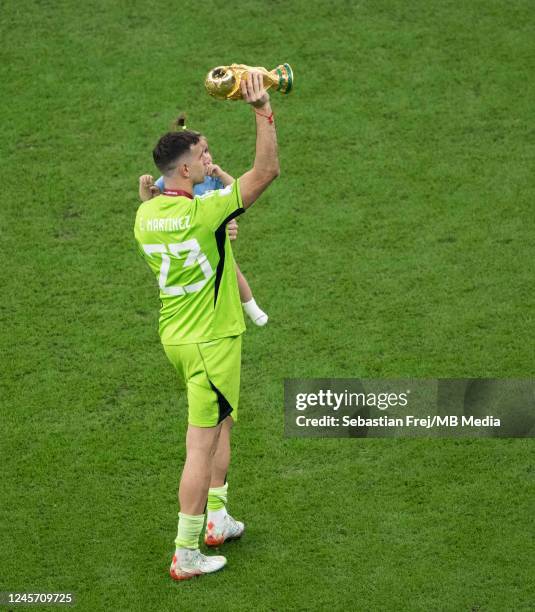 Argentina goalkeeper Emiliano Martinez lifts the FIFA World Cup Trophy after the FIFA World Cup Qatar 2022 Final match between Argentina and France...