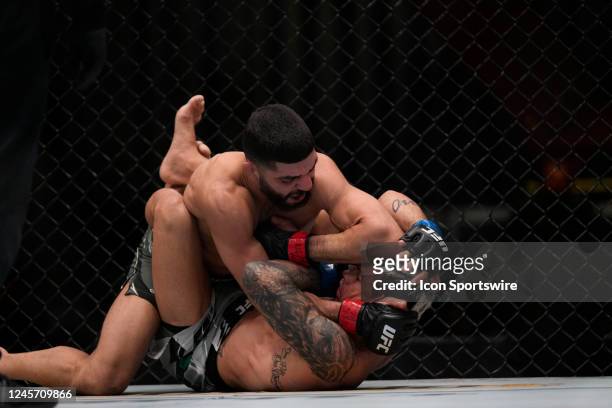 Amir Albazi punches Alessandro Costa in their Flyweight fight during the UFC Vegas 66 event at UFC APEX on December 17, 2022 in Las Vegas, Nevada,...