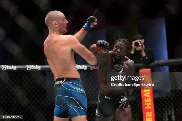 Jared Cannonier punches Sean Strickland in their Middleweight fight during the UFC Vegas 66 event at UFC APEX on December 17, 2022 in Las Vegas,...