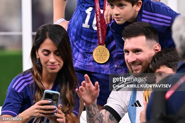 Argentina's captain and forward Lionel Messi celebrates with his wife Antonela Roccuzzo and children after Argentina won the Qatar 2022 World Cup...